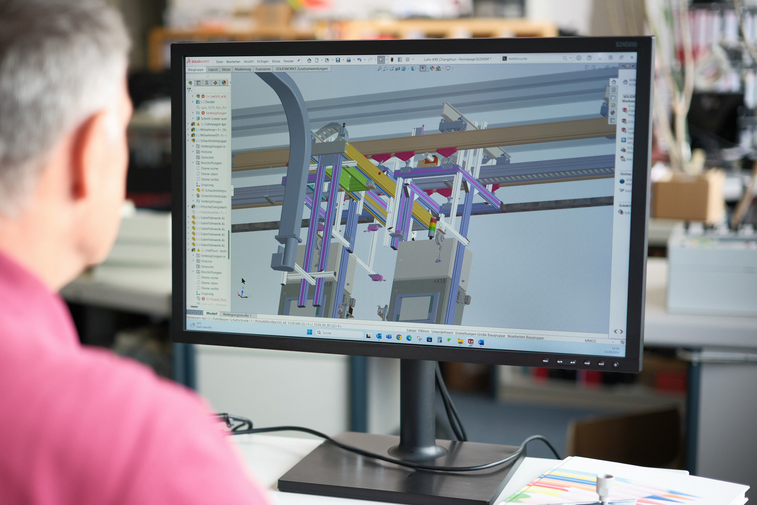 The hero image on the topic of in-line testing (also inline testing) shows an engineer designing an in-line tester (also inline tester) in a CAD program.