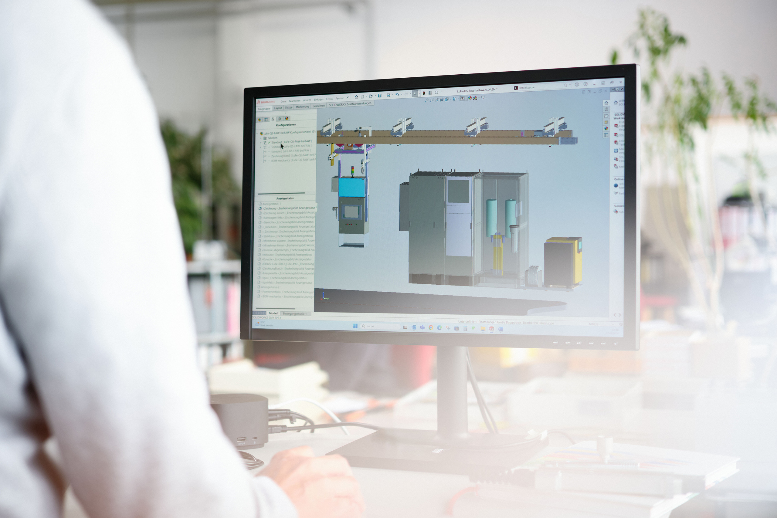 The hero image for the topic custom industrial test benches, test stands and test stations shows one of our engineers working on automated testing stations in CAD software.